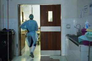 A health worker walks into an operating room in Malawi. 