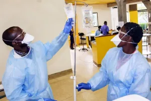 Nurse at Butaro District Hospital prepares IV Fluids for cancer patients