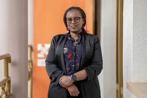 Nadine Karema standing outside of Inshuti Mu Buzima's offices in Rwanda.