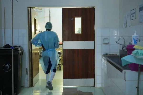 A health worker walks into an operating room in Malawi. 