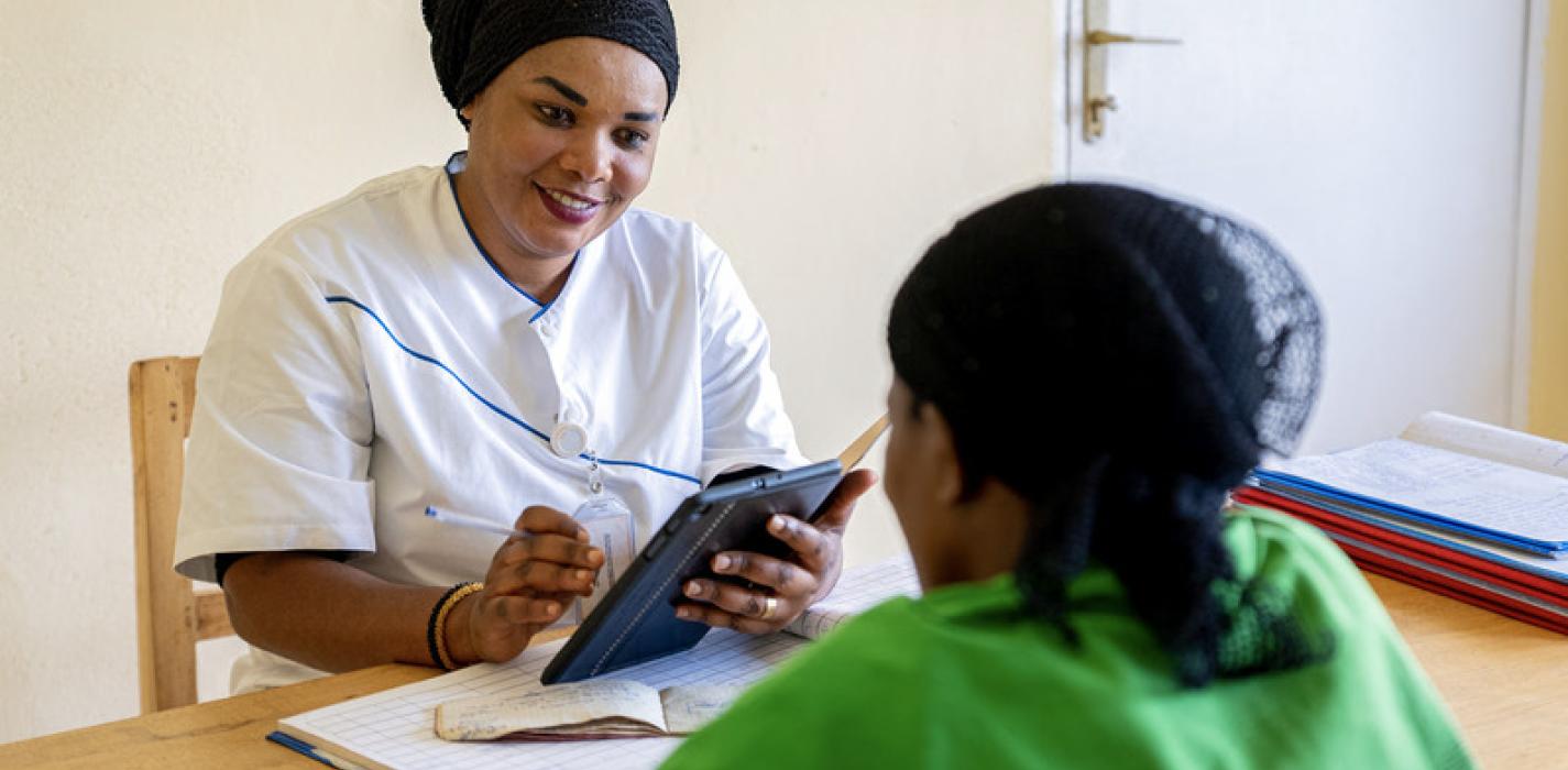 Nurse uses the mUzima app during a consultation with a patient 