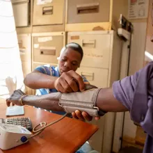 Peer Supporter screens patient for hypertension in Malawi