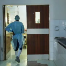 A health worker walks into an operating room in Malawi. 