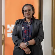 Nadine Karema standing outside of Inshuti Mu Buzima's offices in Rwanda.
