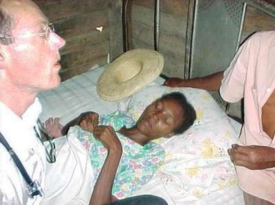 Dr. Paul Farmer visits Adeline Merçon, who is among the first people living with AIDS to benefit from ART in Haiti.
