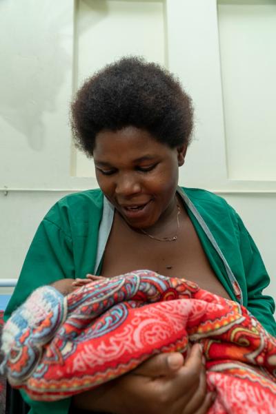 Patient holds her newborn daughter.