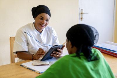 Nurse uses the mUzima app during a consultation with a patient